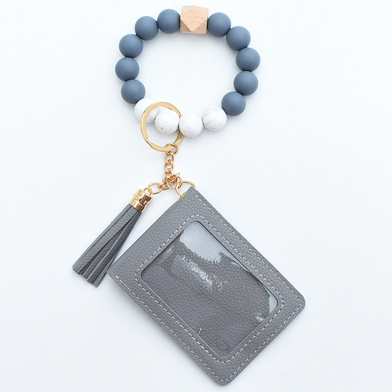 Comercio al por mayor Cuentas de silicona PU Titular de la tarjeta de color sólido Llavero de muñeca